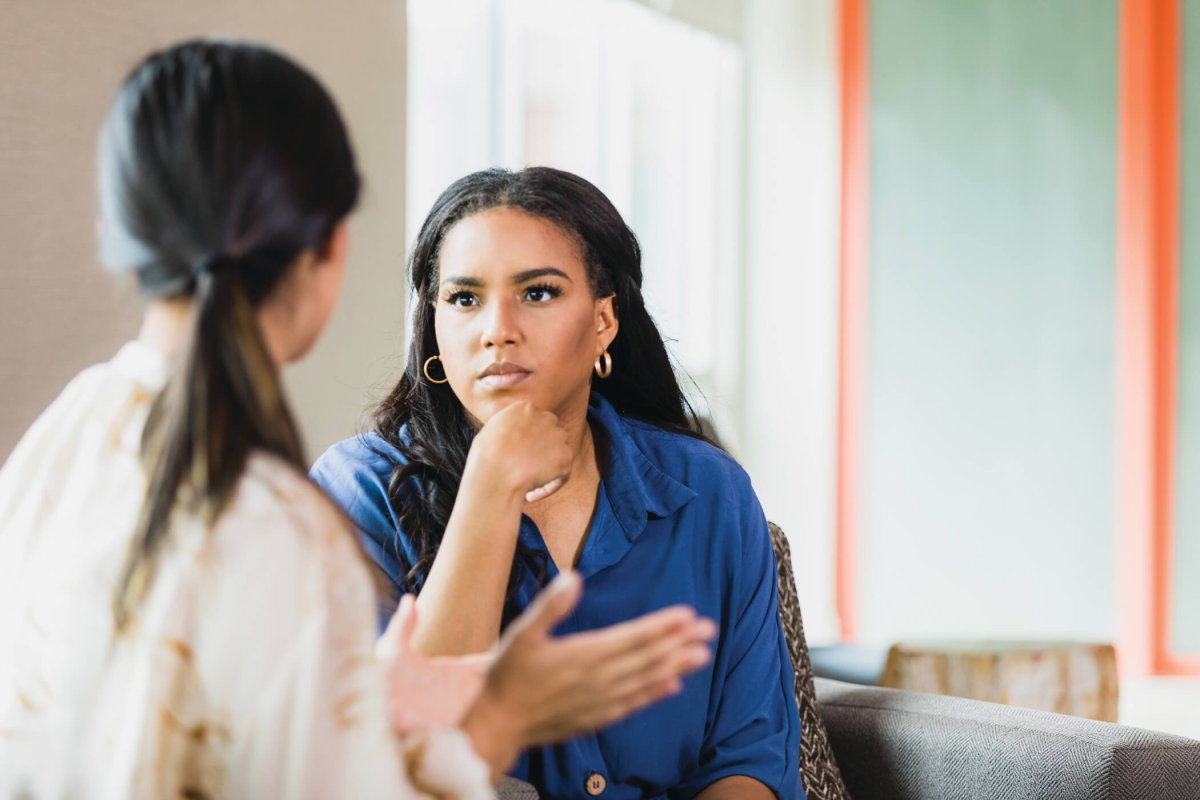 Concerned woman consulting with clinician.