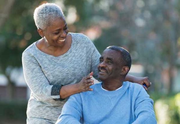 A woman smiling at a man in a chair